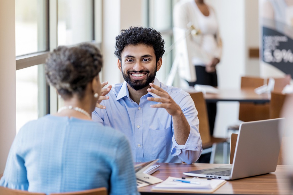 Banking professional in conversation with a customer at a financial institution